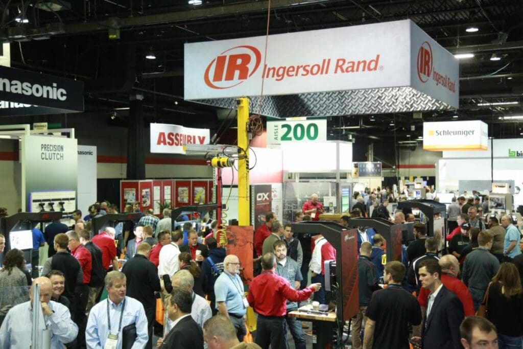 Manufacturing professionals networking at an industry trade show