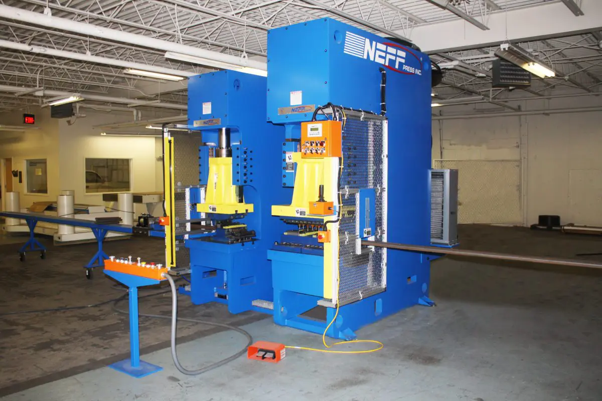 A large machine in a room with some tables