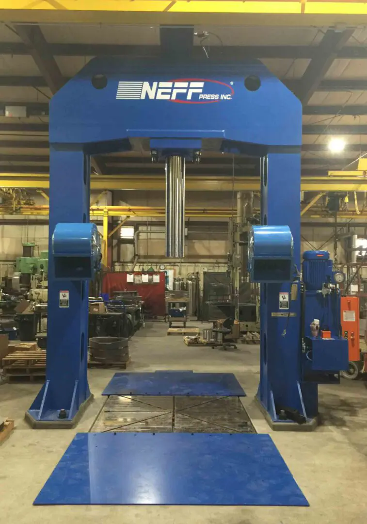 A machine in a factory with some blue equipment