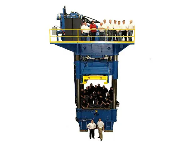 A large blue machine with people standing around it.