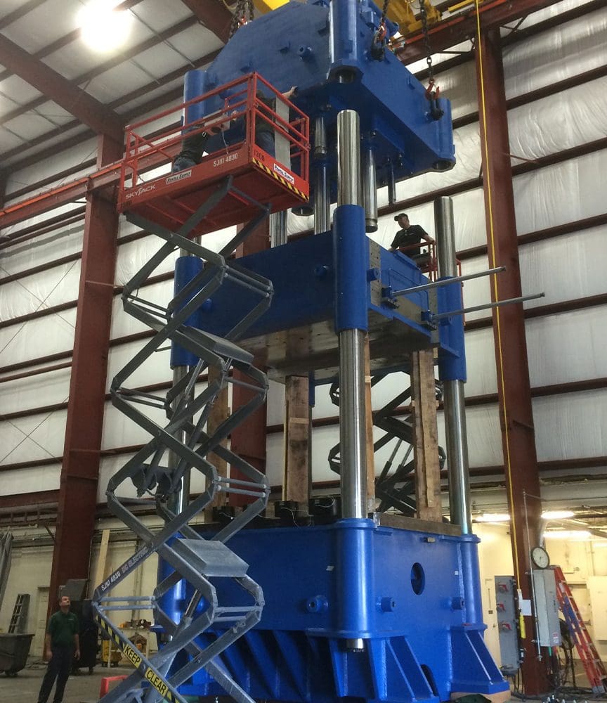 p3 A large machine in a warehouse with workers.