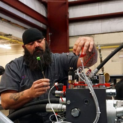 Technical service manager working on hydraulic press.