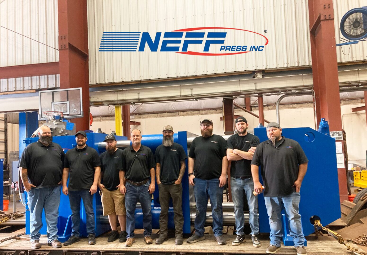 Neff Press engineering and manufacturing team standing in front of a completed press