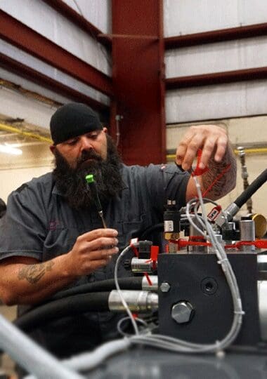 Neff Press Inc. service technician performing field maintenance on a hydraulic press