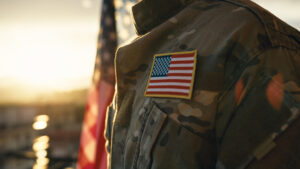 Close-up of an American flag patch on a military uniform at sunset