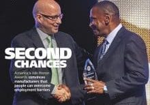 A man and another man are shaking hands.