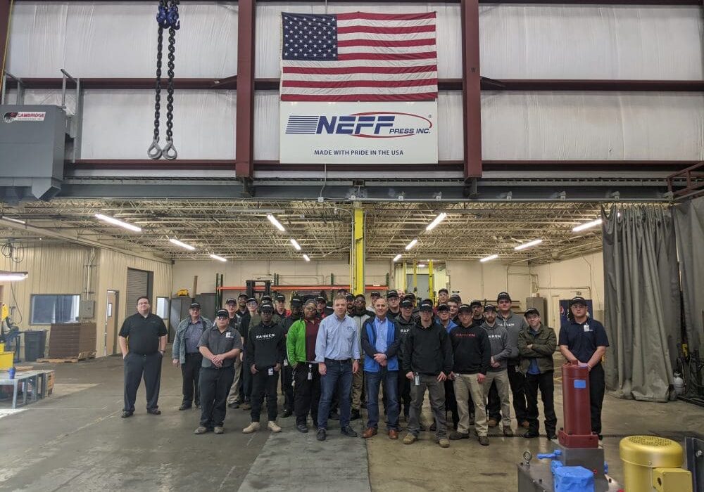 A group of people standing in front of an american flag.